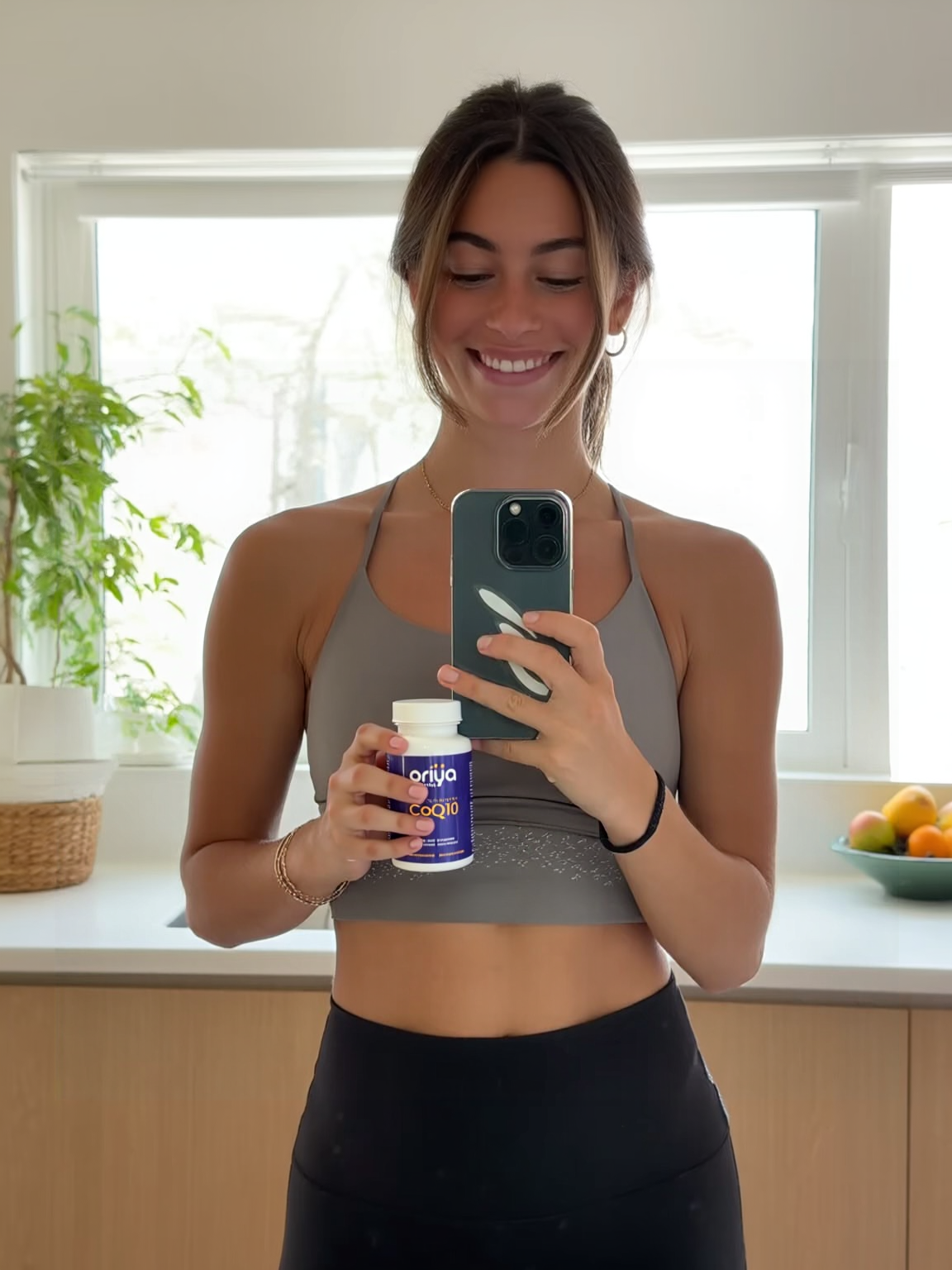 Person holding product outdoors next to fitness gear